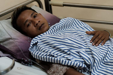 Hendik Maret Diasto at the Marsudi Waluyo Hospital where he is being treated for a snake bite. Diasto was bitten on the ankle while he and his brother were hunting palm civets for sport in a forest ab...