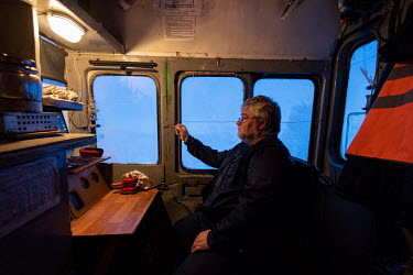 The engineer in the driver's cab of a locomotive on the Obskaya-Bovanenkovo railway that links the Gasprom Bovanenkovo gas field to the outside world.