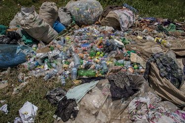 Piles of resellable plastic waste recovered by pickers from an illegal rubbish dump in Banda.