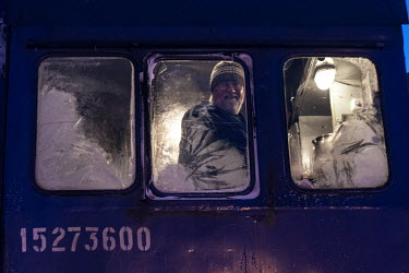 The engineer looks out of the window of the driver's cab while travelling on the Obskaya-Bovanenkovo railway that links the Gasprom Bovanenkovo gas field to the outside world.