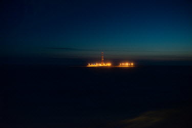 A train travelling along Obskaya-Bovanenkovo railway line, that links the Gasprom Bovanenkovo gas field to the outside world, passes a gas field illuminated in the night.