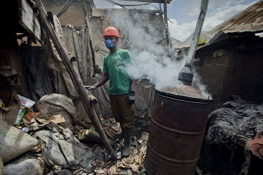 In a backyard workshop, a member of the Lulana Communal Environmentalist group makes briquettes used as cooking fuel as an alternative to charcoal or wood. They manufacture the fuel from recycled or w...