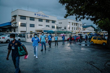 Workers finishing their shift at a Top Glove disposable glove factory. As the company enjoyed record profits this year, thousands of its low-paid workers contracted the coronavirus. Recently Malaysian...