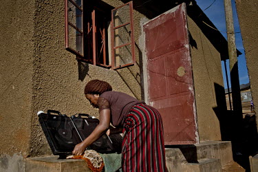 In the district of Kisalosalo, district of Kyebando, in the suburbs of Kampala, Mastulah Nakisozi places a Solvatten solar water purifier in the sun. Nakisozi is part of a group of people infected wit...