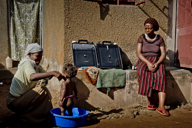 In the district of Kisalosalo, district of Kyebando, in the suburbs of Kampala, Mastulah Nakisozi sits next to a Solvatten solar water purifier that she has placed in the sun while she watches her nei...
