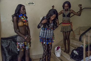 Backstage at the Trash on Fashion Show, at the Kampala National Theatre, models wear clothes and accessories made from plastic bottles and crushed metal bottle caps. The clothes presented during the s...