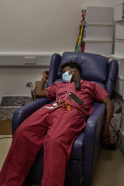 Rui Monteiro Djassi, an exhausted domestic cleaner working on the acute medicine ward at University College Hospital. He is grabbing a short nap after working for 7.5 hours without stopping. He says:...