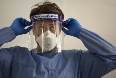 Acute medicine consultant Dr Ben Lovell dons his PPE before entering the secure part of the acute medicine unit at University College Hospital.