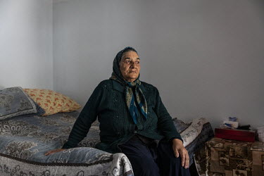 Ulker Allahverdiyeva (78) in the bedroom of her home where she lives with her family in an unfinished school complex where several hundred families have now lived for more than twenty five years after...