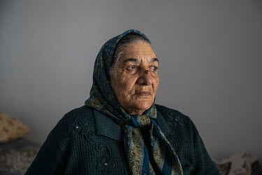 Ulker Allahverdiyeva (78) in the bedroom of her home where she lives with her family in an unfinished school complex where several hundred families have now lived for more than twenty five years after...