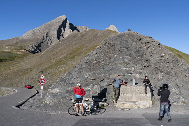 Tourists make pictures at the Italian-French border marker at Col Agnel in Le Queyras National Park in the French Alps.