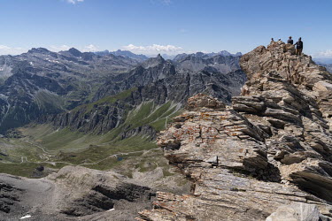 Climbers looking into Italy from the summit of Pain de Sucre in Le Queyras National Park in the Alps on the French-Italian border.