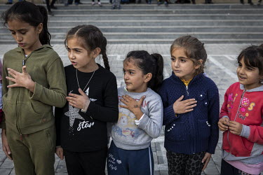 Young children sing the Azerbaijani National Anthem before doing some physical exercise at a school in the city of Barda that has been turned in to a shelter for people who have been displaced by figh...