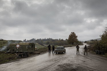 Azerbaijani soldiers and police man a checkpoint on a road outside the recently recaptured town of Fuzuli. Once rich agricultural land it was left in ruin after nearly 30 years of neglect under Armeni...
