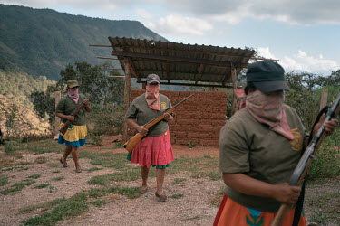 Women carry rifles during a Regional Coordinator of Community Authorities (CRAC-PF) police force gun training demonstration, a year after members of the Los Ardillos drug cartel launched an unsuccessf...