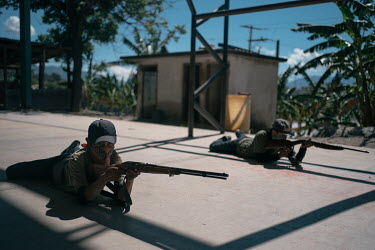 Gerardo (15) holds a rifle as children demonstrate the military skills they have been taught after becoming members of the Regional Coordinator of Community Authorities (CRAC-PF) police force.   CRAC-...