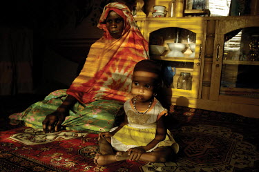 A woman and her two year old daughter, who is being monitored for malnutrition by a nutritional centre, at their home in Mao.