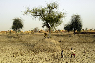 Children play in a dried pond that was excavated near the Koubigou camp for internally displaced persons to collect water for their cattle. However, it dried out due to the large numbers of people wat...