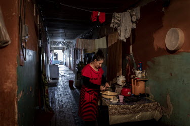 Qaratel Abdinova (46) prepares food in the hallway of a former university dormitory building in Sumgait where she has lived as a refugee since fleeing her home in Nagorno Karabakh in the early 1990s.