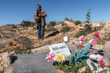 Shamseddine Marzouk stands beside the grave of Rose Marie, a young African woman, who drowned when a migrant boat sank off the north African coast. While many migrants are buried anonymously, after DN...
