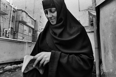 A nun from the Ioann Bogoslov church holding a Bible.