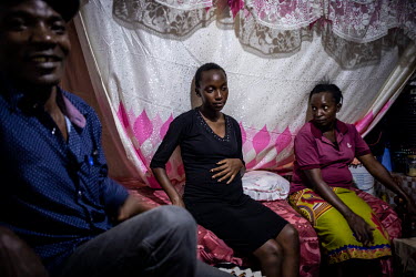 Susan Ndanu (15) sits at home with her parents Eunice and Richard. With schools closed due to the coronavirus pandemic Susan got pregnant after starting a relationship with a boy who said he would giv...