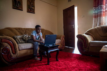 Adrian Murage (12) follows school lessons via Zoom on his laptop at home while the schools are closed due to the coronavirus pandemic.