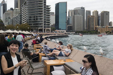 People on the waterfront with the Central Business District and Circular Quay, the main ferry terminal, behind them.