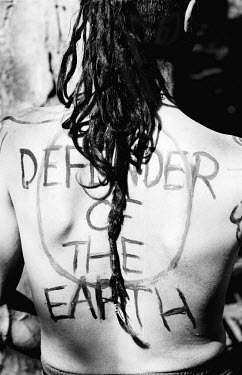 A person with 'Defender of the Earth' written on their back during a protest against the extension of the M65 motorway through Stanworth Valley.