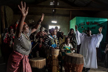 A priest leads a church service of Batwa (pygmy) people who were displaced from their forest homes. Until 1992 the Batwa people lived in the forests of Western Uganda but they had to make way for the...