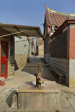 An old and seldom-used water pump amid the maze of traditional residences in Beishan village. Kinmen Island has been facing water scarcity problems for years, suffered a severe drought in 1996, and si...