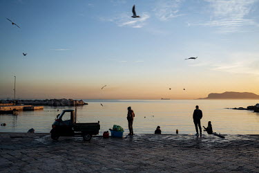 Fisherman getting ready to go fishing early in the morning at the Sant Erasmo marina.