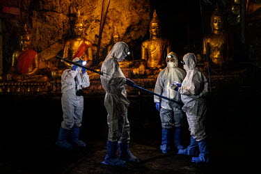 A team of researchers use nets to catch bats at the Khao Chong Pran Cave near Buddha statues.A team of researchers consisting of scientists, ecologists, and officers from Thailand's National Park Depa...