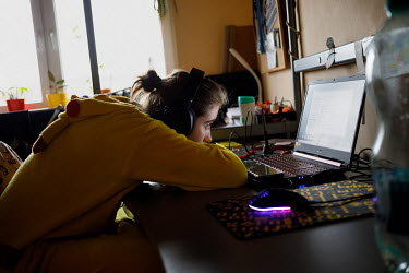 Julia, 19, a secondary school student, at home during her online lessons. All lessons have been online since the pandemic began in March 2020. 'I have my alarm clock set to 7.58am for school at eight....