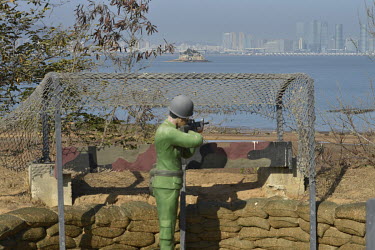 A manequin soldier keeps vigil on Xiao (Little) Kinmen Island against the risk of invasion from the Chinese mainland, visible in the distance a mile or two away.  Following the retreat of Chiang Kai-s...