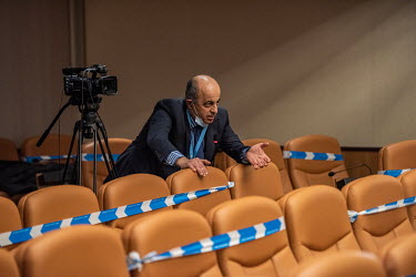 Member of the press askng a question (having removed his face mask to do so) at a hybrid press conference at the end of a fifth round of UN-sponsored peace talks (the Syrian Constitutional committee),...