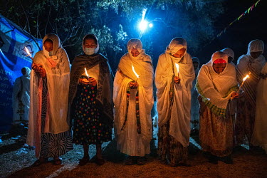 Pilgrims burn candles during a night time vigil during Timkat, celebrating the baptism of Jesus and the Orthodox Epiphany. The official slogan for the 2021 celebrations was 'Ethiopia's Rebirth at Gond...