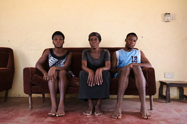 Akpertiyo Lawer, who estimates her age at 90, at her home in Matsekope, a village on Ghana's salt-rich Songor Lagoon. Pictured with her grandchildren, Roberta Sottie, 17, and Obed Sottie Obed, 21, she...