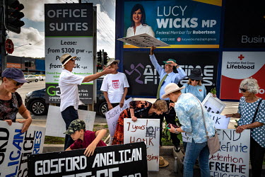 Members of the Anglican Parish of Gosford, joined by social justice supporters, protest the government's treatment of asylum seekers on a busy intersection in Gosford, near the office of Lucy Wicks MP...