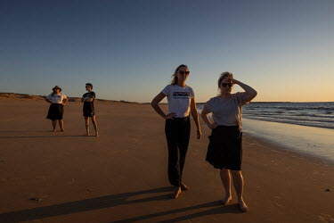 North Australian Aboriginal Justice Agency (NAJA) staff, LR: Caitlin Shepherd, John Blackley, Holly Fitzsimmons and Kate Ballard relax and watch sunset on a beach near Wadeye prior to the week's heari...