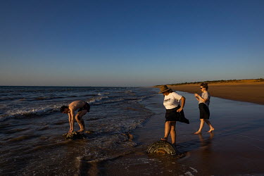 North Australian Aboriginal Justice Agency Lawyers (NAJA) John Blackley (L), Caitlin Shepherd (centre) and Kate Ballard (R) relax and watch sunset on a beach near Wadeye prior to the week's hearings a...