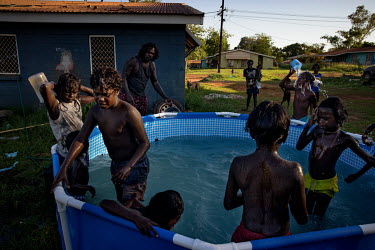 Children cool off in an backyard pool. Wadeye is very hot most of the year with most days registering over 30 degrees Celsius with very high humidity especially in summer.