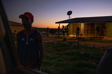 North Australian Aboriginal Justice Agency (NAJA) client support officer Caitlin Shepherd (not pictured) talks to a man outside his home to inform him that he is required to attend court the following...