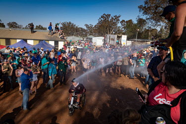 Partygoers are sprayed with water during the 'Wet T Shirt' competition at the Ariah Park Bachelor and Spinster ball. The town's fire truck sprays water on to the crowd and shortly after the women are...