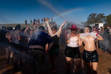 Partygoers are sprayed with water during the 'Wet T Shirt' competition at the Ariah Park Bachelor and Spinster ball. The town's fire truck sprays water on to the crowd and shortly after the women are...