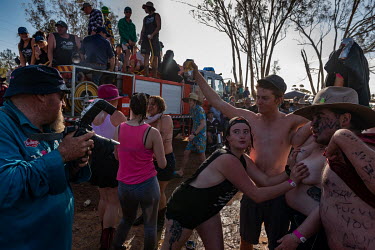 After the 'Wet T Shirt' competition, many of the men and some of the women start play fighting and wrestling in the mud at the Ariah Park Bachelor and Spinster ball. 'Rippy', a well known photographer...