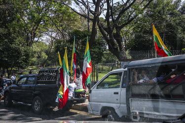 Following the army's takeover of power in a military coup, pro-military supporters arrive in trucks, playing military anthems, at an assembly point prior to a march through the city centre.