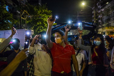 People flash their mobile phone lights while singing anti-military anthems, after calls for protest went out on social media in opposition to the 1 February 2021 military coup.