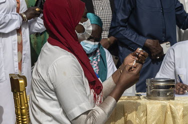 A medical worker prepares a dose of the Chinese Sinopharm vaccine. After receiving 200,000 doses of the Sinopharm vaccine, the immunisation campaign in Senegal began with a ceremony where former Prime...