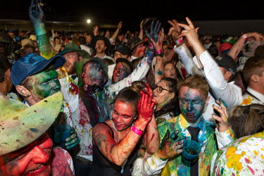 Partygoers covered in food dyes dance at the Ariah Park Bachelor and Spinster ball. Although food colouring is technically banned at the ball (security guards search patrons as they enter) It is still...